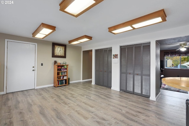 interior space featuring two closets and light hardwood / wood-style flooring