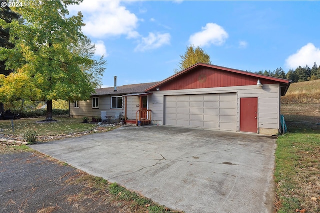 ranch-style house with a garage and a front yard