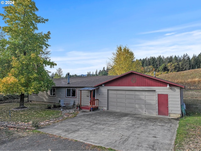 single story home with a garage and a front yard