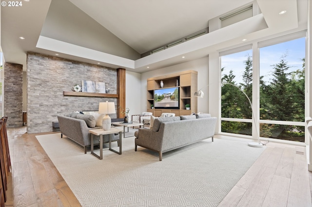 living area featuring wood-type flooring, recessed lighting, and high vaulted ceiling