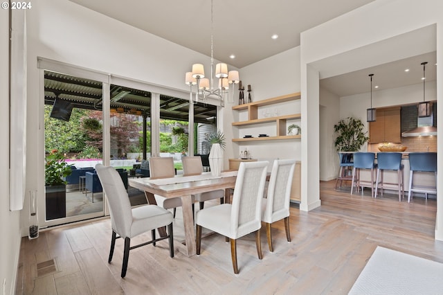 dining area with a chandelier, recessed lighting, and light wood-type flooring