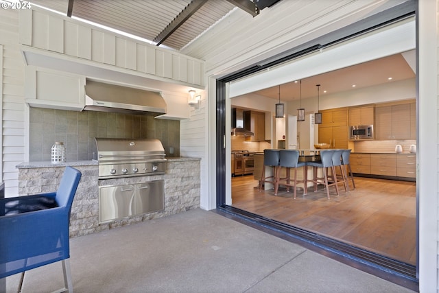 view of patio with area for grilling and a grill