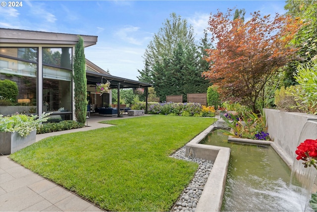 view of yard with a patio area and outdoor lounge area