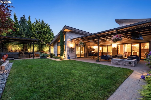 rear view of house with an outdoor hangout area, a patio area, a yard, and a hot tub