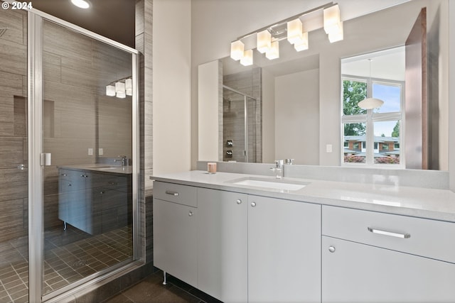 full bathroom featuring a stall shower, vanity, and tile patterned flooring