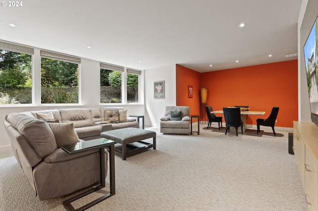 living room with light colored carpet, recessed lighting, and baseboards