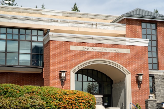 view of exterior entry with brick siding