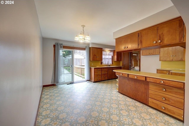 kitchen with sink, hanging light fixtures, and a chandelier