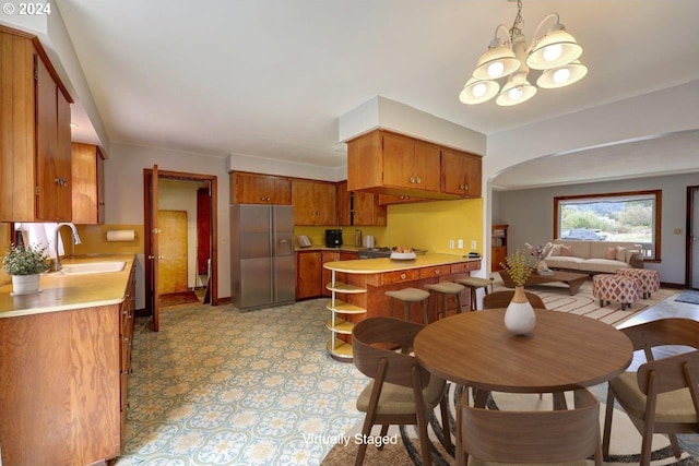 dining room with a notable chandelier and sink