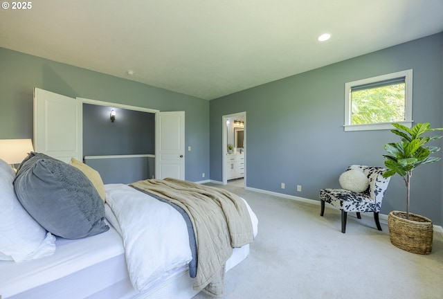 bedroom featuring light colored carpet, recessed lighting, baseboards, and ensuite bathroom