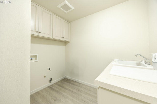 laundry room with washer hookup, electric dryer hookup, visible vents, cabinet space, and light wood-style floors