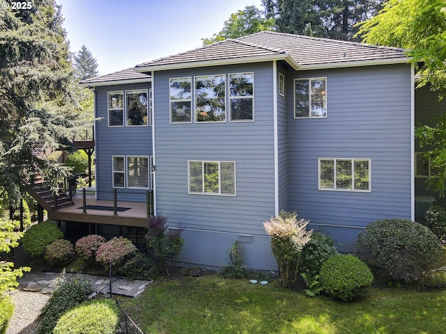 rear view of property featuring a deck