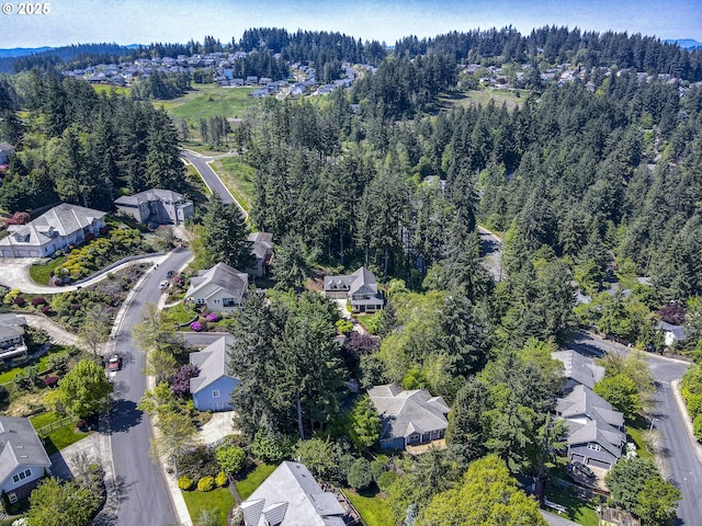 bird's eye view featuring a forest view and a residential view