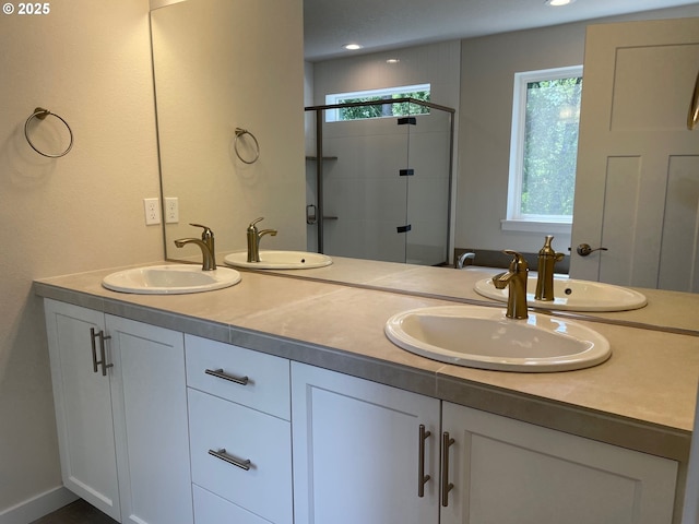 17344 SW Wapato Island Dr Unit 27, Sherwood, OR 97140 - bathroom featuring a shower stall, double vanity, and recessed lighting