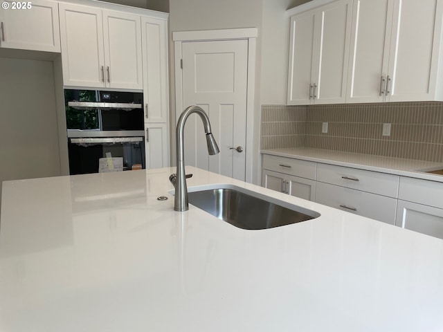 17344 SW Wapato Island Dr Unit 27, Sherwood, OR 97140 - kitchen featuring a sink, tasteful backsplash, and light countertops