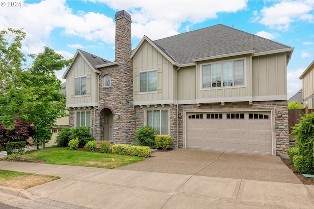 view of front of home featuring a front yard and a garage