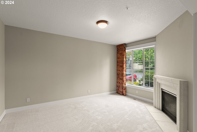 unfurnished living room featuring light colored carpet and a textured ceiling