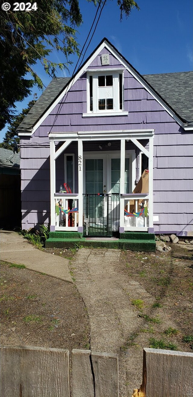 rear view of house featuring a porch