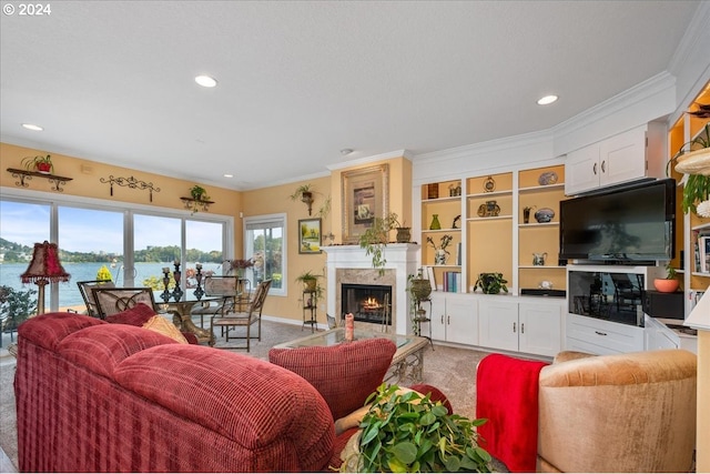 living room featuring a premium fireplace, ornamental molding, carpet floors, and a water view