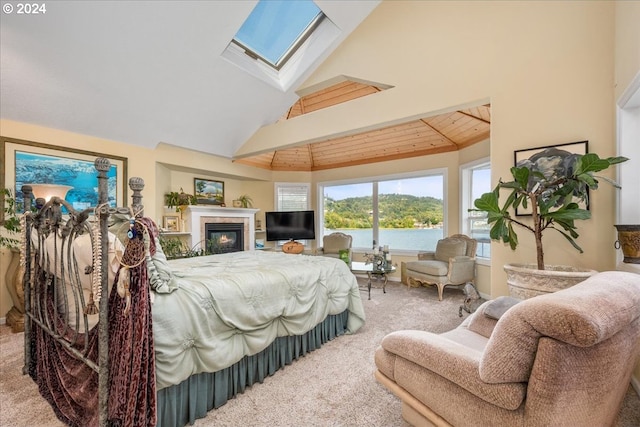 bedroom featuring wood ceiling, lofted ceiling with skylight, and carpet