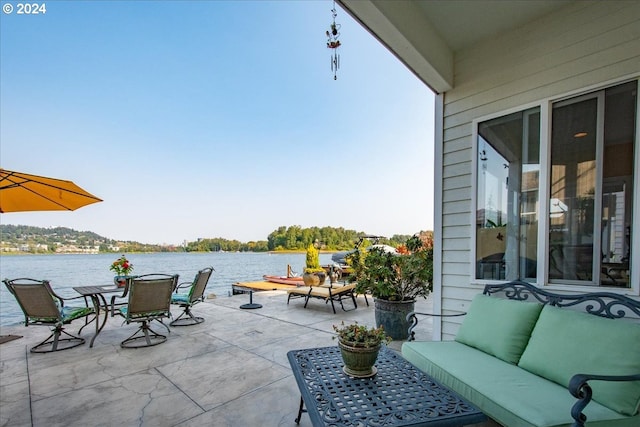 view of patio / terrace featuring an outdoor hangout area and a water view