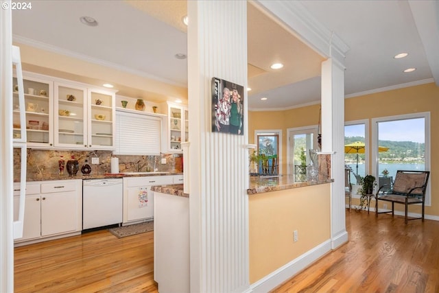 kitchen with light wood-type flooring, white cabinets, dishwasher, and stone counters