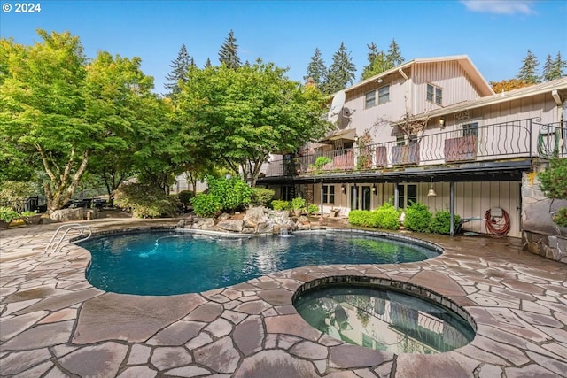 view of pool featuring an in ground hot tub and a patio