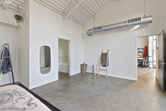 interior space with high vaulted ceiling and concrete flooring