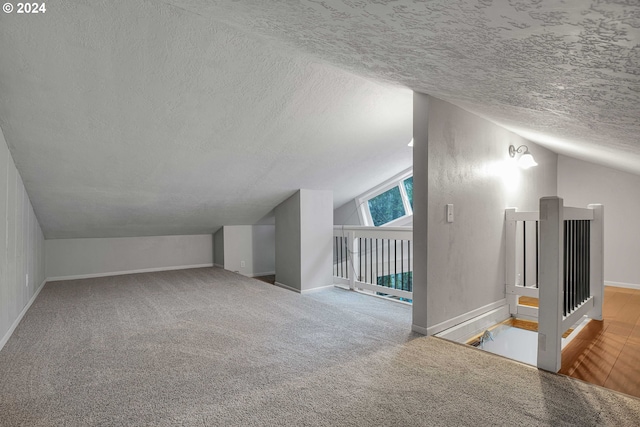 22715 SW Eagle Point Rd, Sheridan, OR 97378 - additional living space featuring lofted ceiling, a textured ceiling, baseboards, and carpet