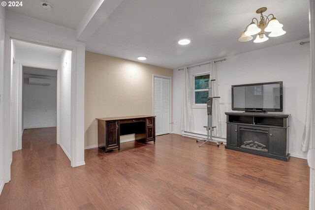 living area featuring a notable chandelier and hardwood / wood-style flooring