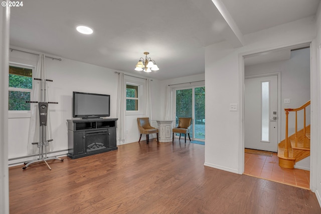 22715 SW Eagle Point Rd, Sheridan, OR 97378 - living room with stairs, a chandelier, wood finished floors, and baseboards