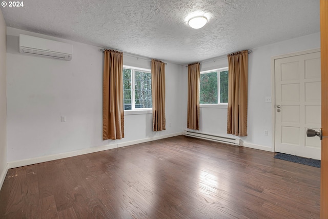 22715 SW Eagle Point Rd, Sheridan, OR 97378 - empty room featuring a baseboard heating unit, an AC wall unit, a textured ceiling, wood finished floors, and baseboards