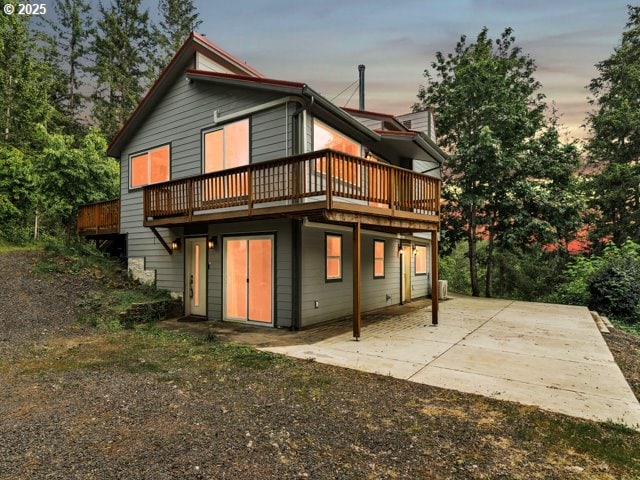 22715 SW Eagle Point Rd, Sheridan, OR 97378 - back of house at dusk with a wooden deck and a patio area