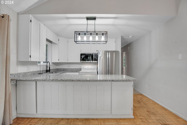 22715 SW Eagle Point Rd, Sheridan, OR 97378 - kitchen with stainless steel appliances, a sink, a peninsula, light stone counters, and vaulted ceiling