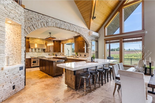 kitchen featuring a center island, high vaulted ceiling, pendant lighting, high end stainless steel range, and wood ceiling