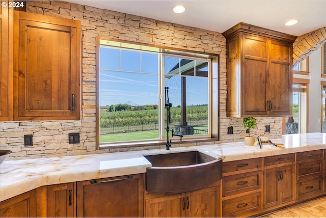 33138 SE Bluff Rd, Boring, OR 97009 - kitchen featuring a sink, decorative backsplash, brown cabinetry, light stone countertops, and recessed lighting
