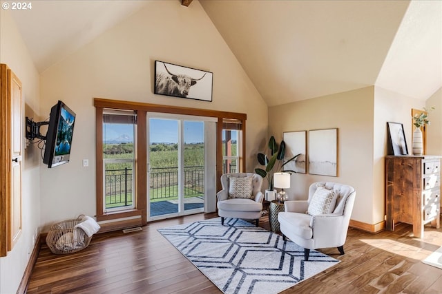 sitting room with vaulted ceiling with beams and hardwood / wood-style flooring