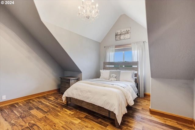 bedroom featuring a chandelier, hardwood / wood-style flooring, and lofted ceiling