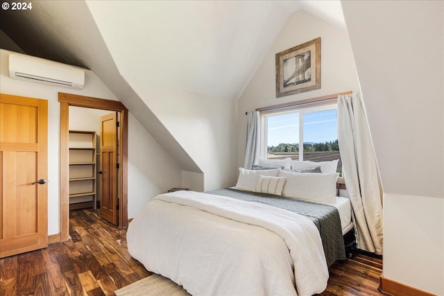33138 SE Bluff Rd, Boring, OR 97009 - bedroom with a wall mounted air conditioner, vaulted ceiling, dark wood-style flooring, and a walk in closet