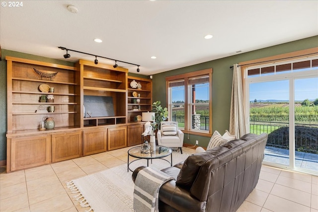 tiled living room featuring rail lighting