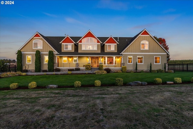 view of front of home with a yard and a porch