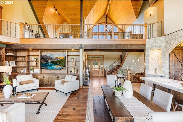 33138 SE Bluff Rd, Boring, OR 97009 - living area with high vaulted ceiling, wooden ceiling with exposed beams, stairway, wood finished floors, and rail lighting