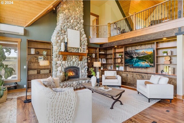 living room featuring wooden ceiling, a wall mounted air conditioner, high vaulted ceiling, hardwood / wood-style floors, and a fireplace