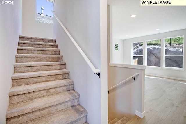 stairs with wood-type flooring