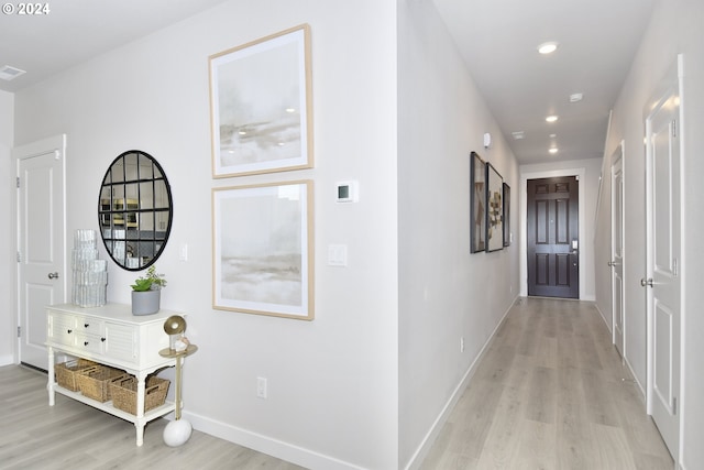 corridor with light hardwood / wood-style flooring