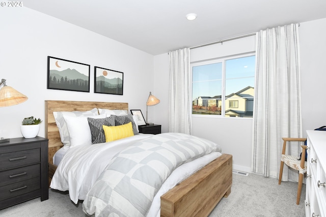 bedroom featuring light colored carpet