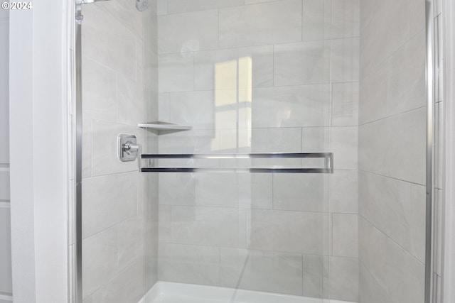 bathroom featuring a shower with door