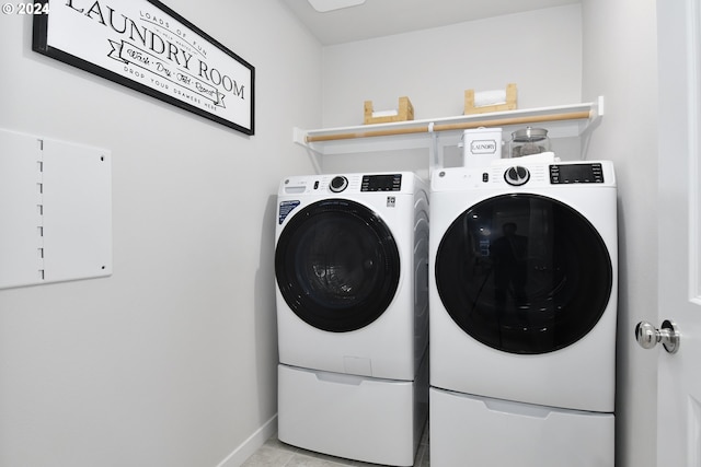 laundry room featuring separate washer and dryer and light tile patterned flooring