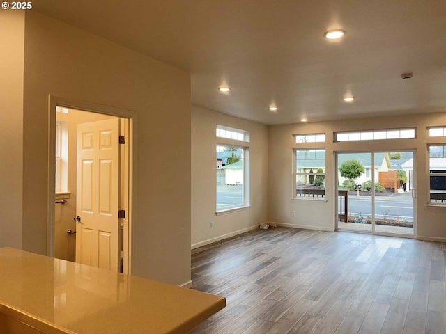 interior space with recessed lighting, baseboards, and wood finished floors