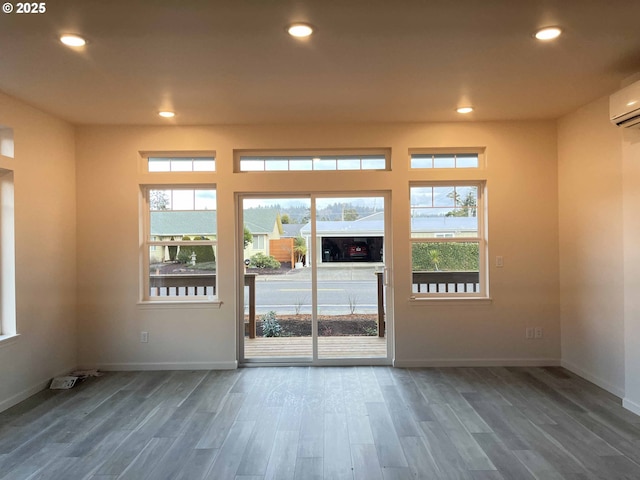 doorway to outside with baseboards, wood finished floors, and recessed lighting